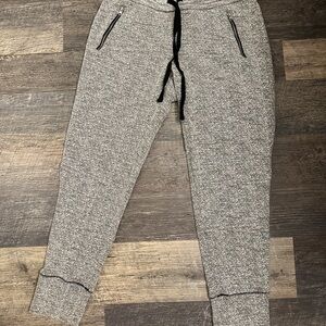 Aerie Heathered Gray Joggers with Black Accents and zipper pockets.